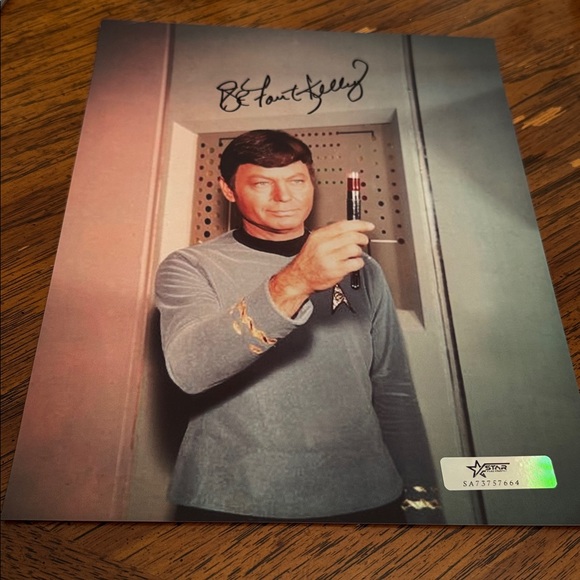 Deforest Kelley the star of the Star Trek franchise signed a photo.